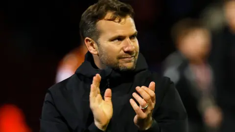 Tom Cleverley claps at the end of a game