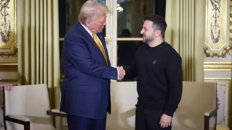 EPA A handout picture made available by the Presidential Press Service of Ukraine shows US President-elect Donald Trump (L), and Ukrainian President Volodymyr Zelensky (R) shaking hands during their meeting with French President Emmanuel Macron (not pictured) at the Elysee Palace, as part of ceremonies marking the reopening of the Notre Dame de Paris Cathedral, in Paris, France, 07 December 2024.