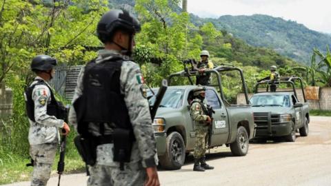 Soldiers keep watch after people fled armed gang violence, which has forced residents to evacuate with the help of government authorities that set up camps for displaced individuals, in Tila, Chiapas state, Mexico June 12, 2024.