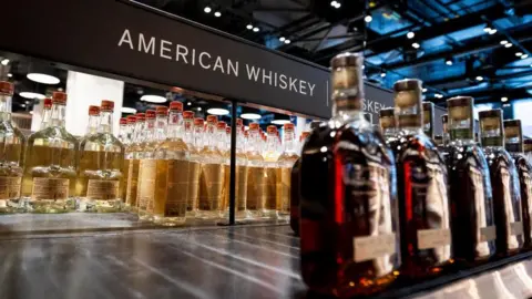 Getty Images An empty shelf at an Ontario liquor store under the sign 'American Whiskey'. 