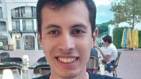 AFP A  young man called Quentin Deranque sits outside