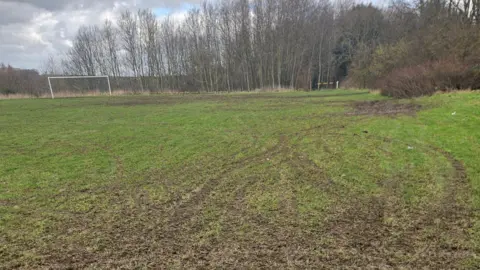 Tyre tracks from off-road bikes on a football pitch