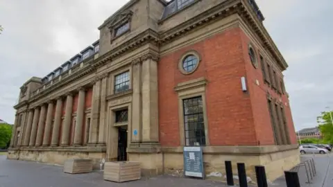 Middlesbrough Council Corner view of Middlesbrough Library, a sandstone and brick building dating from the beginning of the 20th Century.