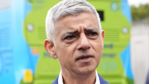 PA Media Mayor of London Sir Sadiq Khan standing in front of a bus in Kew on 11 May 2026.