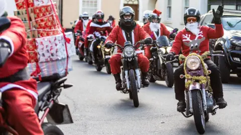 PLAN.COM A line of motorcyclists dressed as Santa taking part in a rideout.