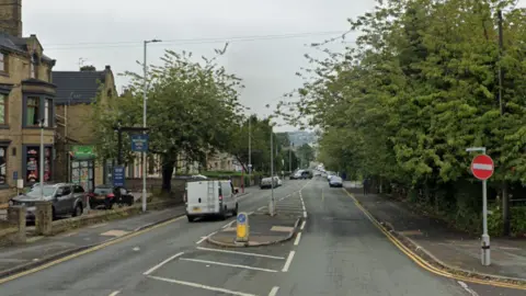 A Google street view image of Easby Street - a long single-carriage way road with a pedestrian crossing in the middle and stop sign to the right