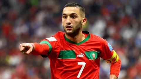 Hakim Ziyech points during a match for Morocco