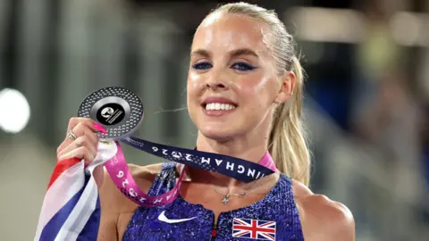 Keely Hodgkinson poses with her silver medal after the women's 800m final