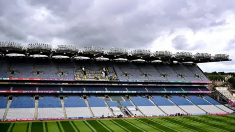 Getty Images A large empty seating stand at a sports ground looking onto a green pitch