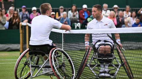 Ben Bartram and Alfie Hewett talk over the net at Wimbledon