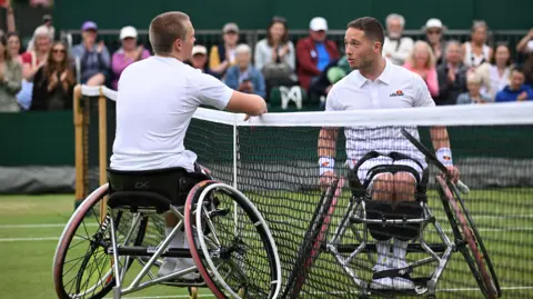 Ben Bartram and Alfie Hewett talk over the net at Wimbledon