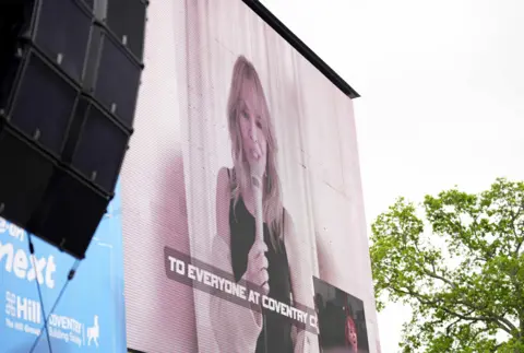 PA Media Kylie Minogue on a video screen at War Memorial Park. Fans have created a popular chant for star Jay Dasilva to the tune of Kylie’s ‘Can’t Get You Out of My Head’ hit song. 