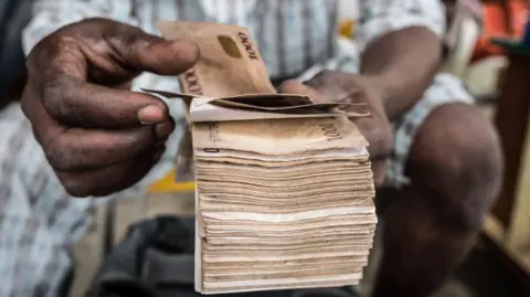 Getty Images Big wad of naira notes
