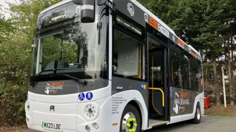 An on-demand electric bus in Shropshire, showing the sign Connect On-Demand.