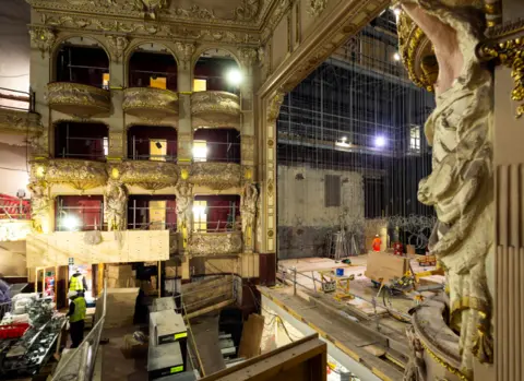 Anneleen Lindsay A side view of the King's Theatre stage during construction the stage is covered with ropes and pieces of wood but the recognisable stalls and statues on the side of the stage are still visible 