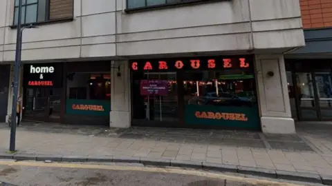 Google The front of Home & Carousel in Leeds. The venue is indicated by a sign above its doors. 