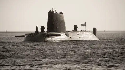 MOD Nuclear submarine HMS Astute moving towards its base at Faslane