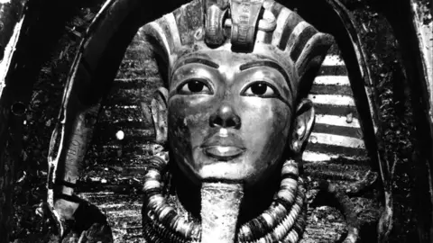 Griffith Institute/Harry Burton A black and white image of the iconic burial mask of Tutankhamun.