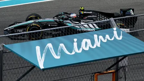 Kimi Antonelli drives past a Miami sign 