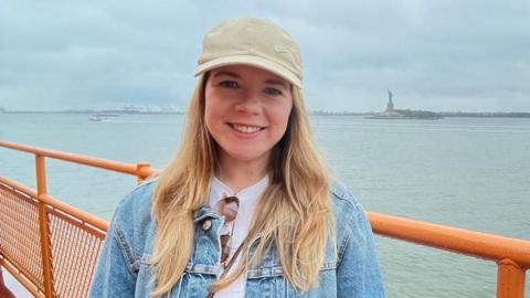 Vicky on a ferry in New York with the Statue of Liberty in the background