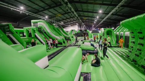 Total Ninja Large green inflatable assault course.