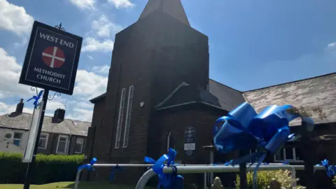 Blue ribbons outside West End Methodist church in Jay Slater's home town of Oswaldtwistle