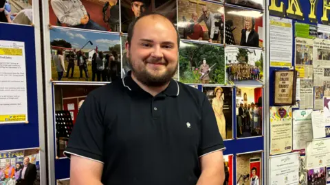 LDRS A man in a polo top with short dark hair and a beard.