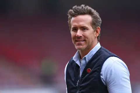 Getty Images Ryan Reynolds ahead of the Emirates FA Cup Fifth Round match between Wrexham and Chelsea at Racecourse Ground on March 7, 2026 in Wrexham, Wales. (Photo by Robbie Jay Barratt - AMA/Getty Images)