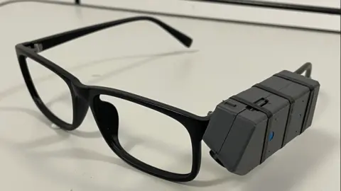 University of Reading Black framed glasses with a big black box attached to the right hand arm which records and takes photos.