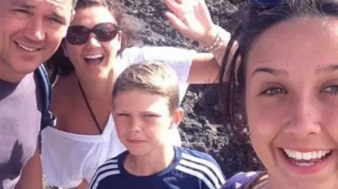 Family handout Family photograph with Olly centre, and his mum Lorraine front