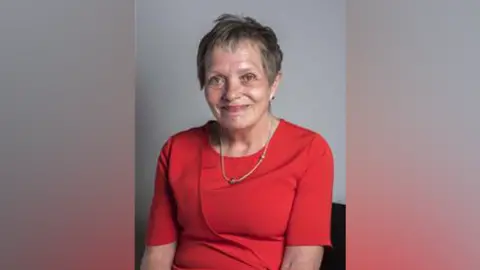 City of Wolverhampton Council Sue Roberts wearing a red dress in an official party photograph