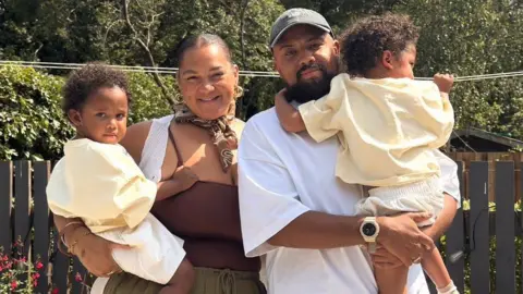 Grace Victory Grace and her partner Lee with their two children