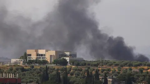 Smoke billows from southern Lebanon following an Israeli strike, as seen from Nabatieh, Lebanon, June 13, 2026