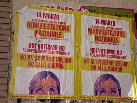 A poster in Rome advertising the march against Meloni's proposed judicial reforms. The poster features a photo of Meloni cropped from the nose up. 