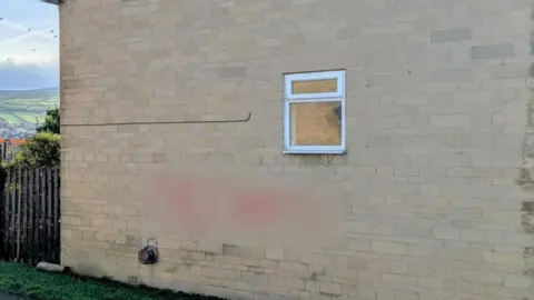 Damien Greenhalgh Blurred image of the racist graffiti on a residential property