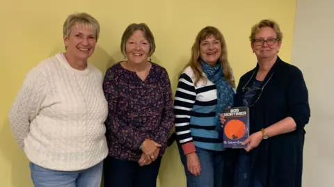 Eileen Welby Eileen (second from the left) with three other members of one of her books club. One of them on the right is holding a copy of Bob Mortimer's book 'Satsuma'