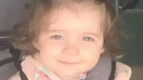 Head-and-shoulders image of Isabelle Rose Welsh. She is smiling directly into the camera and has dark hair. She is wearing a pink top.