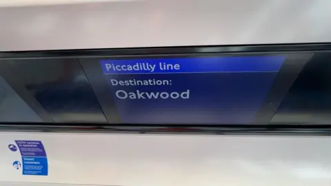 A digital sign shows the destination as Oakwood