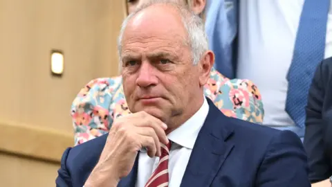 Getty Images A general view of Sir Steve Redgrave, dressed in a dark blue suit, at Wimbledon in 2024.
