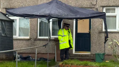 police office under tent at murder scene