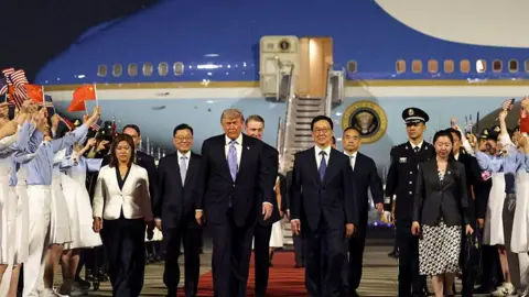 Donald Trump is joined by Vice-President of China Han Zheng and other Chinese officials as he arrives in Beijing on 13 May