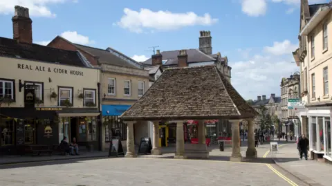 Chippenham town centre. Several buildings are lining the shop.