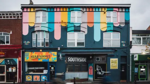 Hammo and Jay building covered in multicoloured design as part of Withington Walls Project