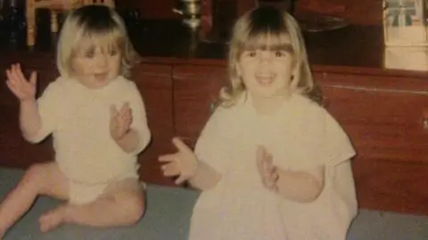 Family photo A picture of Nikita Dallison and Mellissa Arkwright in 1994. Both girls are smiling and clapping in the image. 