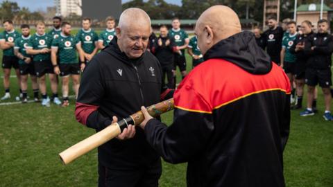 Wales head coach Warren Gatland is presented with a didgeridoo by Aboriginal representative Dean Duncan