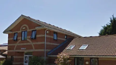 Google The Cutlers Hill Health Centre, a modern building where the utilitarian red-brick frontage is interspersed with narrow lines of lighter bricks