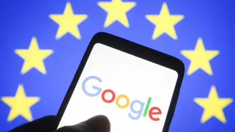 Getty Images Google logo displayed on a phone in front of the EU flag - yellow stars on a blue background.