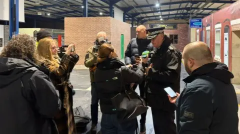 GMP Stephen Watson stands and speaks to the media during the raids at GMP HQ.