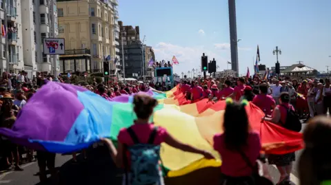 REUTERS/Toby Shepheard People carry a giant rainbow flag, as they take part in the Brighton & Hove Pride Community Parade during the annual Brighton Pride Festival in Brighton