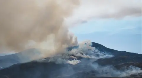 Pat O'Neill Smoke from a mountain fire climbs high into the atmosphere